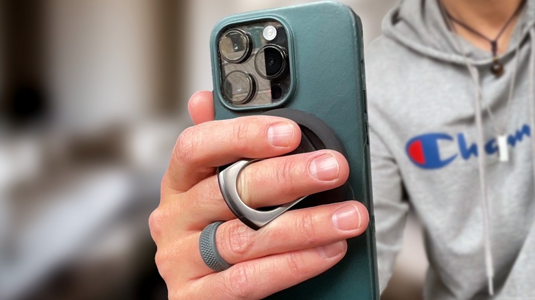 Holding iPhone 14 Pro with Belkin MagSafe Mount as ring grip