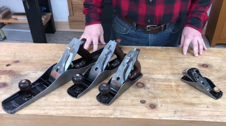 A selection of hand planes on a bench.