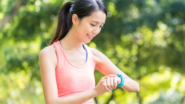 woman using apple watch