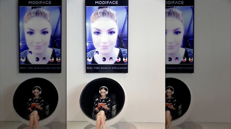 Woman using ModiFace app on a tablet