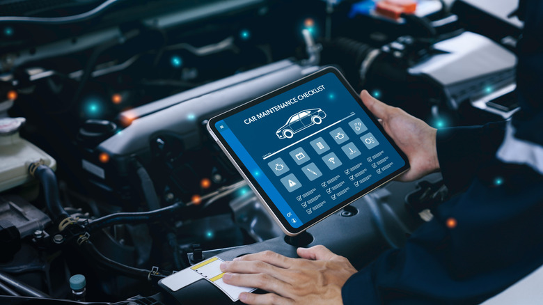 A mechanic diagnosing engine problems on a car