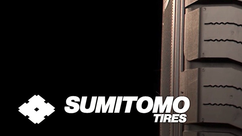 Logo for Sumitomo tires backed by tire tread