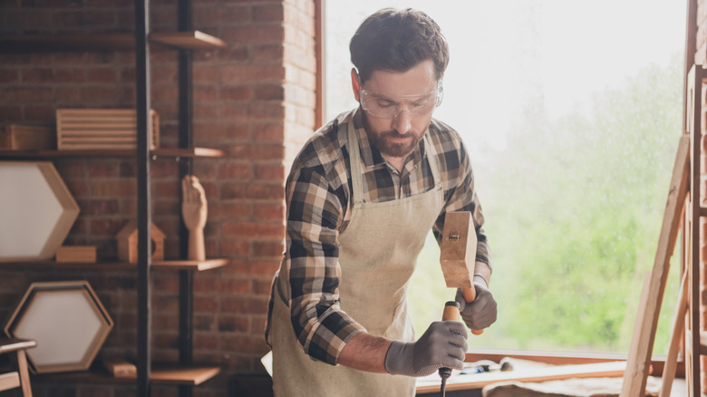 Man working with chisel and hammer