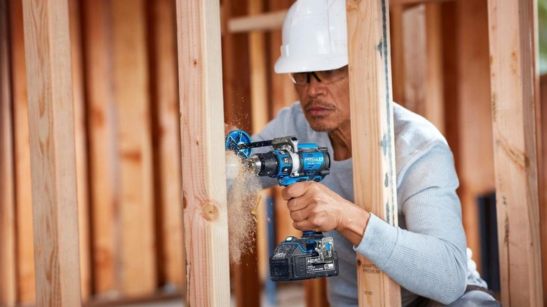 person using hercules drill