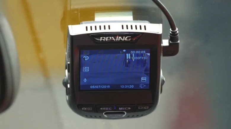 Close-up of Rexing V1-4K Ultra dashcam attached to a windshield, viewed from interior