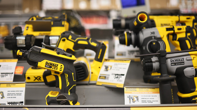 DeWalt tools on display in a store, some info on tags is out of focus