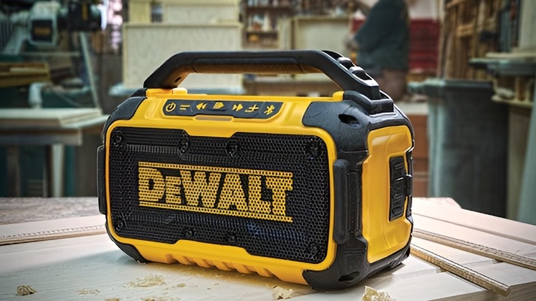 DeWalt Bluetooth speaker sitting on wooden table