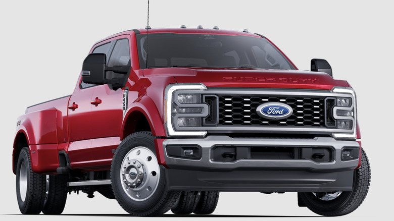 Red Ford F-450 Super Duty Lariat dually truck on white background