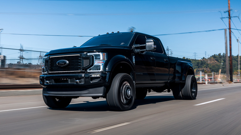 A black Ford F-450 on the highway
