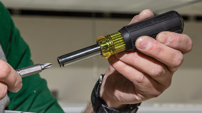 User changing the tip of a Klein Tools driver