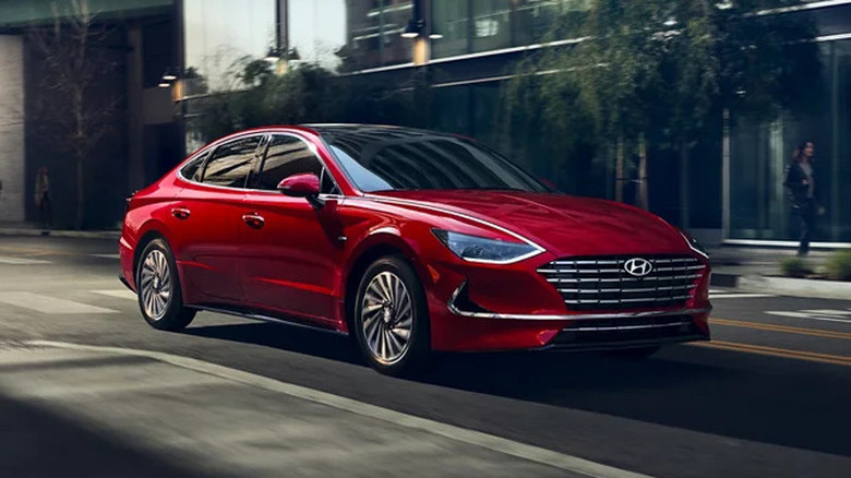 Red 2023 Hyundai Sonata Hybrid driving
