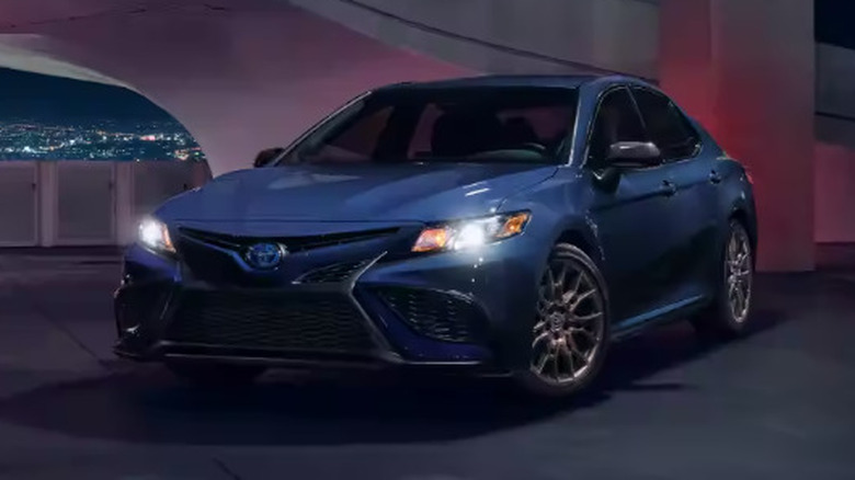 Blue 2023 Toyota Camry Hybrid in parking garage
