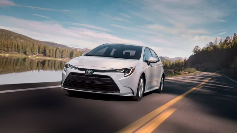 White 2023 Toyota Corolla Hybrid driving