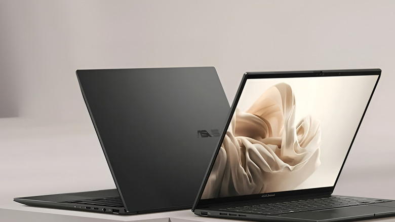 Two ASUS laptops sitting up back to back on