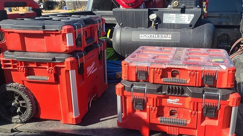 Four Milwaukee toolboxes, one being a rolling toolbox