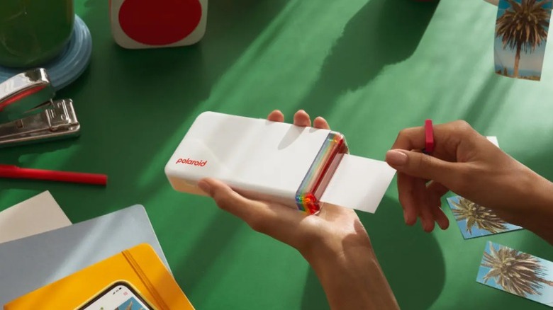 Person using the Polaroid Hi-Print to print a photo