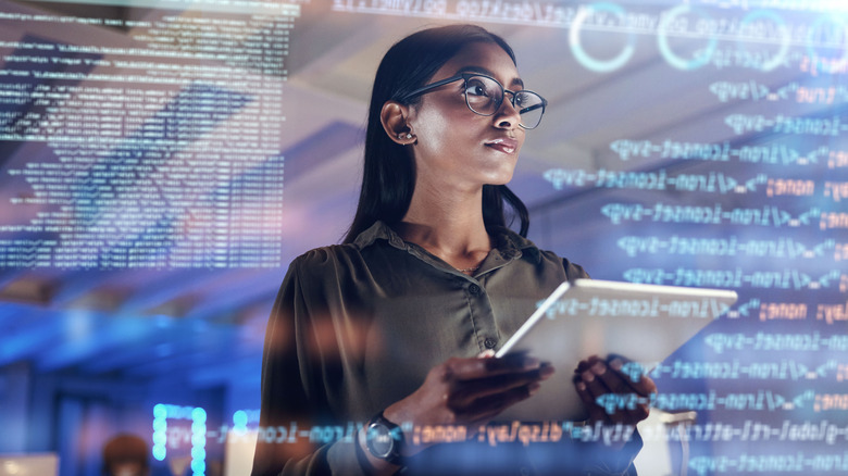 woman on tablet thinking of data analytics