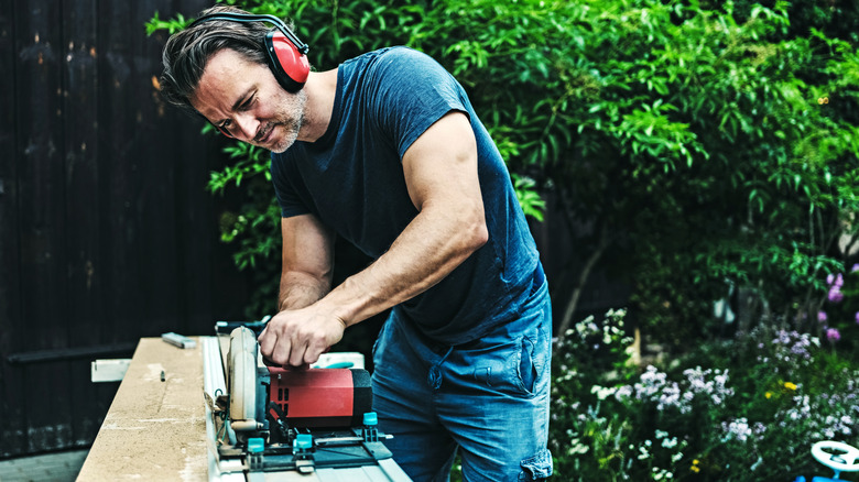 Man using a circular saw working outside