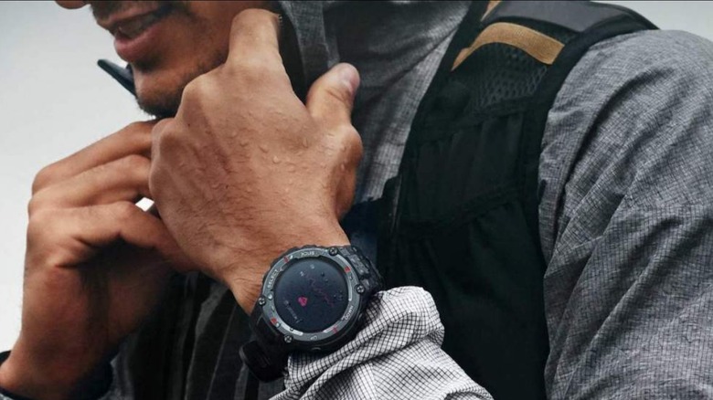 person wearing fitness watch in rain 