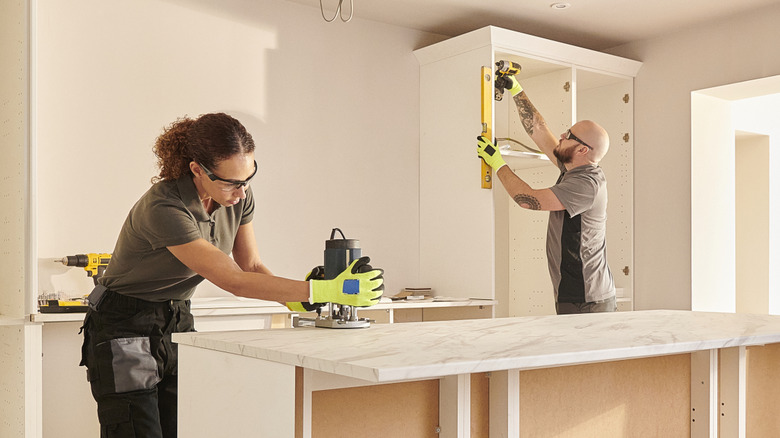two people remodeling kitchen