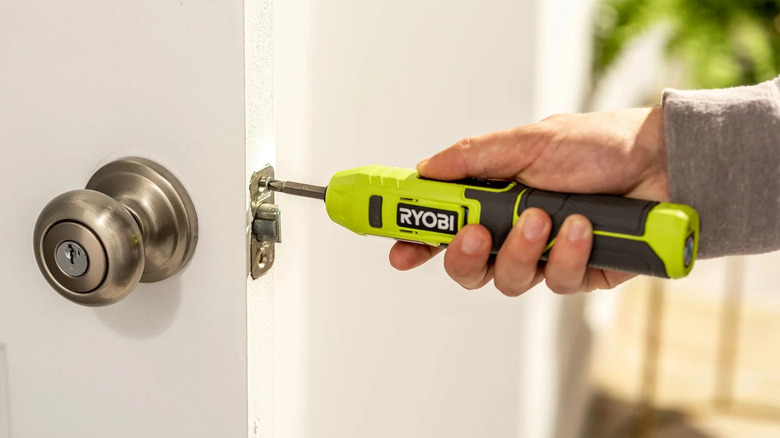 Ryobi Cordless Screwdriver being used to fix door latch