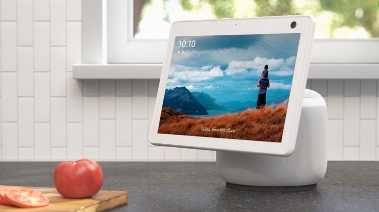 An Amazon Echo Show 8 displaying a picture along with the time and the current temperature