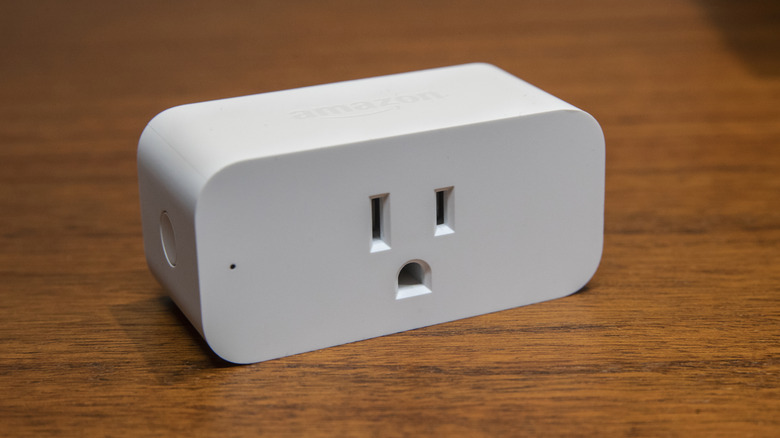 An Amazon smart plug on a wooden table