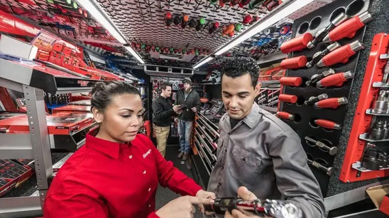 Snap-on employees and shoppers looking at tools
