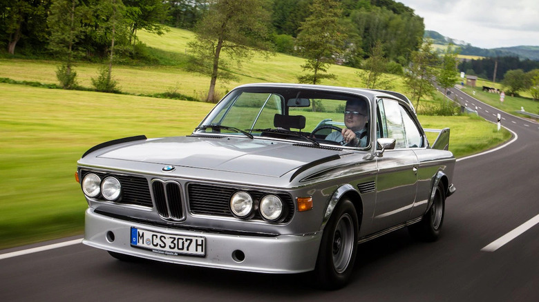 BMW 3.0 CSL driven at speed on an open road front 3/4 view