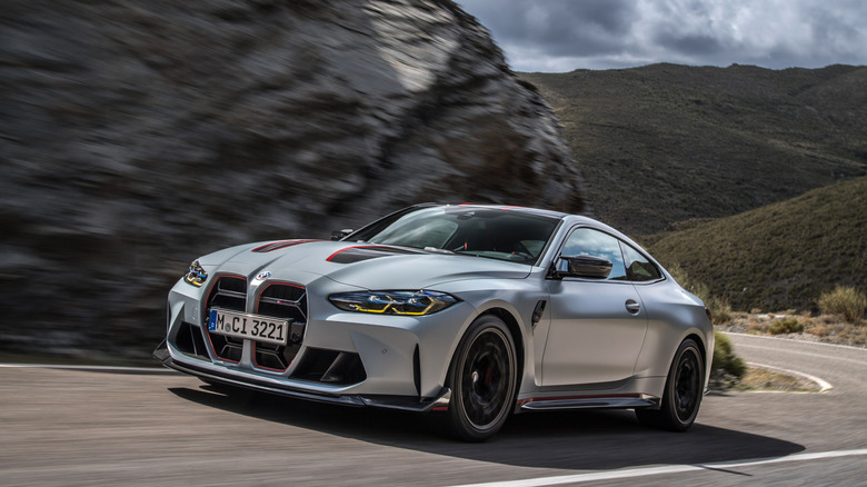 BMW G82 M4 CSL driven at speed on a public road front 3/4 view