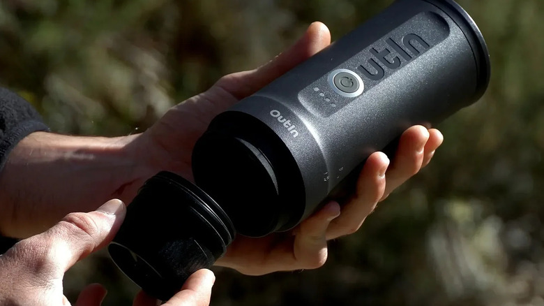 person holding portable espresso machine
