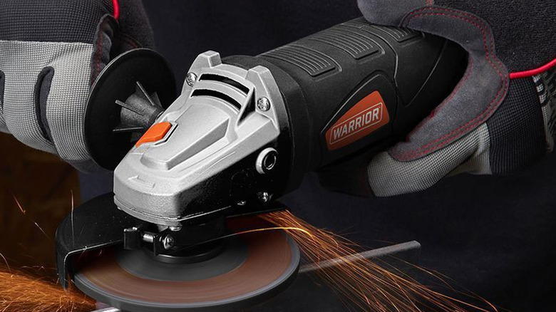 person using warrior angle grinder