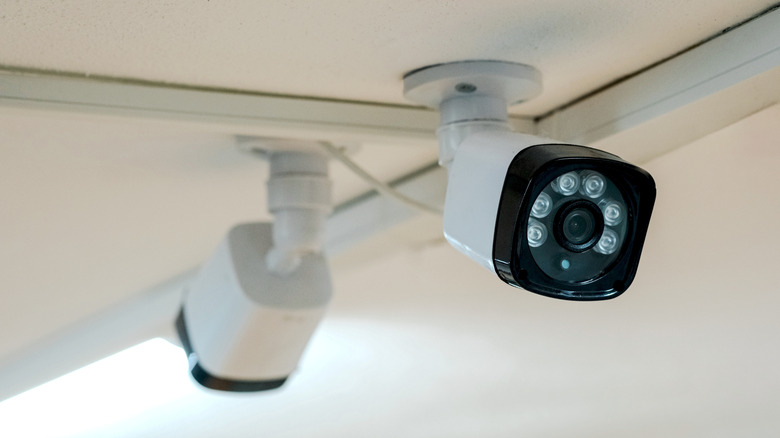 Two security cameras with IR LEDs mounted on a ceiling