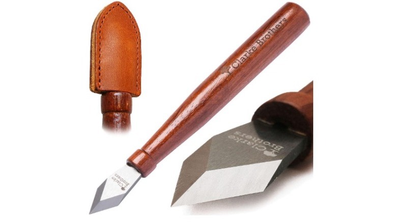 Makring knife with brown handle and leather sheath