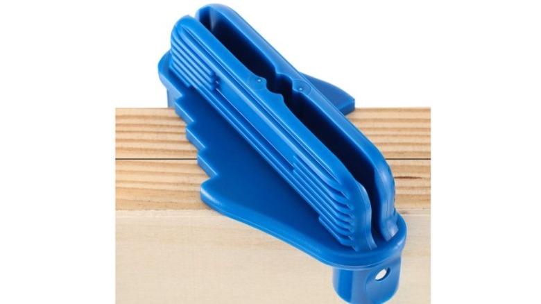 Blue center finder on wood