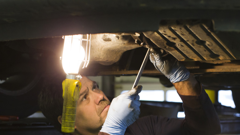 mechanic working with an old-style hook light