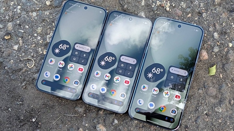 Three Google Pixel devices side-by-side on pavement