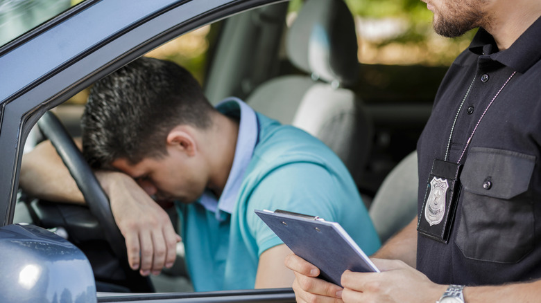 Driver slumped in despair after getting a speeding ticket
