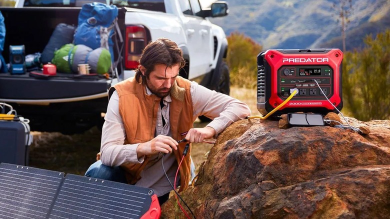 Guy connecting a Predator power station to a solar panel
