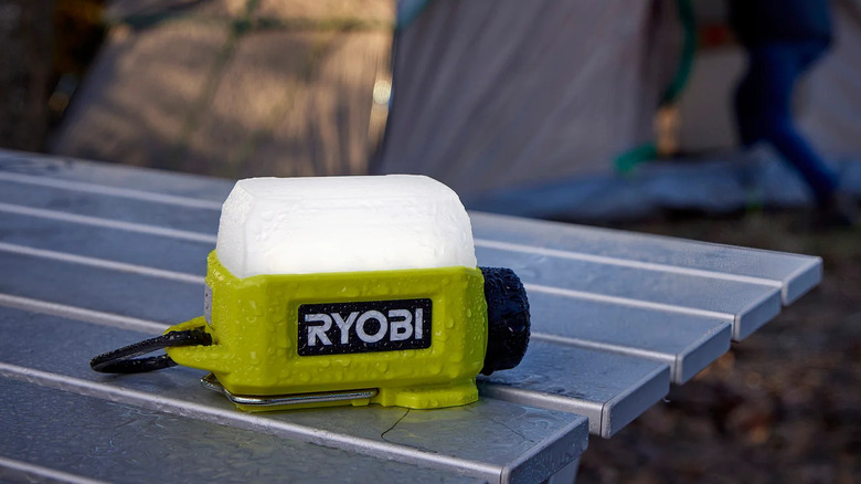 Ryobi USB Lithium Area Light sitting on a camping table