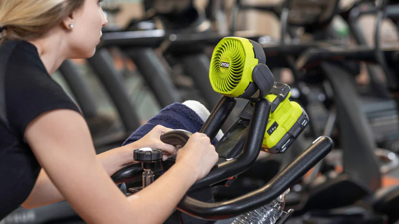 Ryobi One+ 18V Cordless 4 Inch Clamp Fan attached to an exercise bike