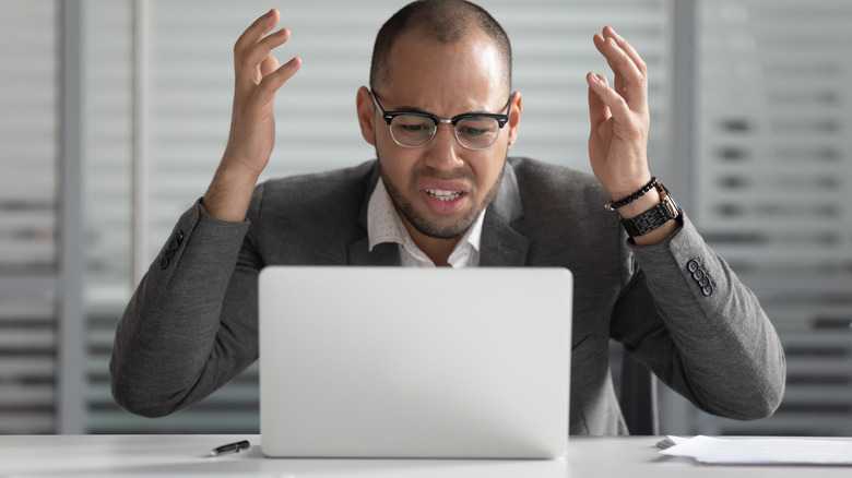 Angry person staring at laptop