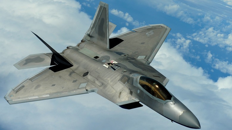 F-22 Raptor flying among clouds