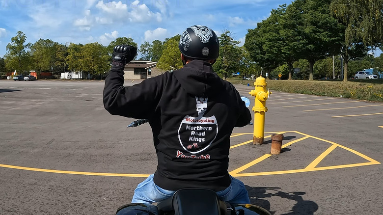 Motorcycle Rider using hand signal indicating right turn