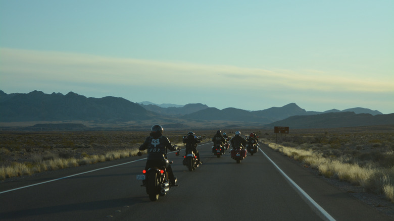 A group of motorbikers riding on a highway.