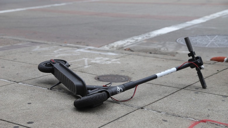 Bird scooter lying on sidewalk