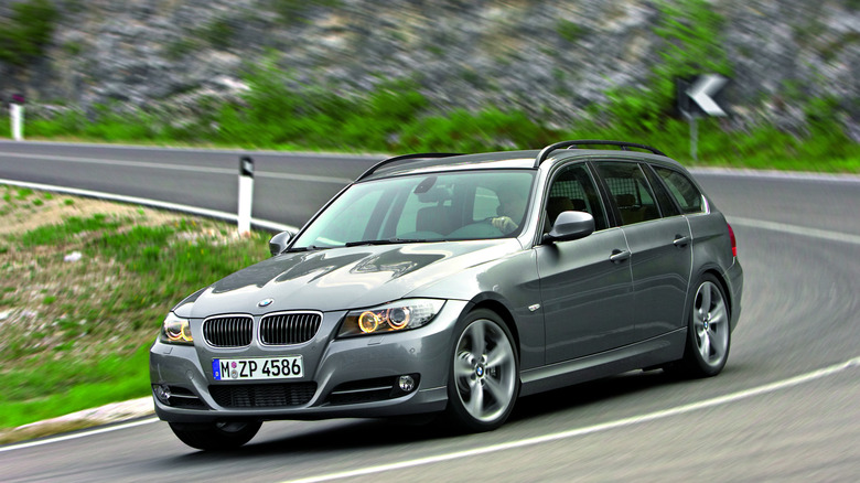 2009 BMW 3-series wagon driving on mountain road, front-left 3/4 view