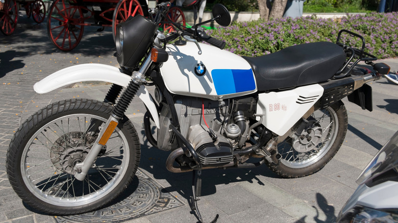 BMW R80 GS parked on the sidewalk.