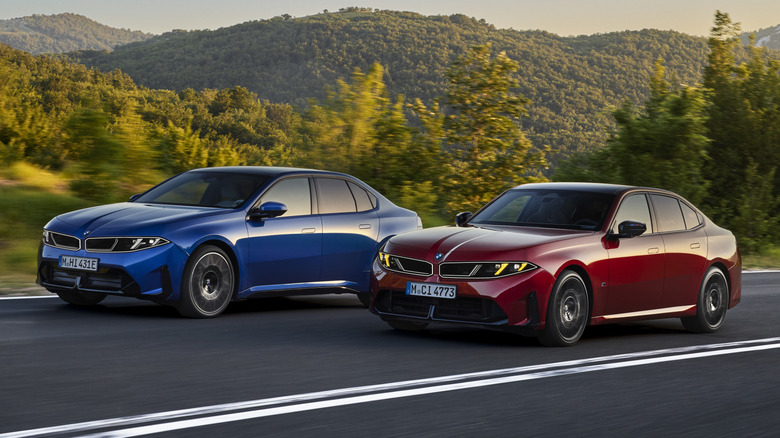 Red 2027 BMW 3 Series and Blue i3 driving side-by-side