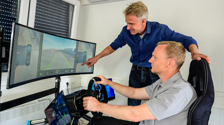 A man driving BMW's teleoperated parking test vehicle